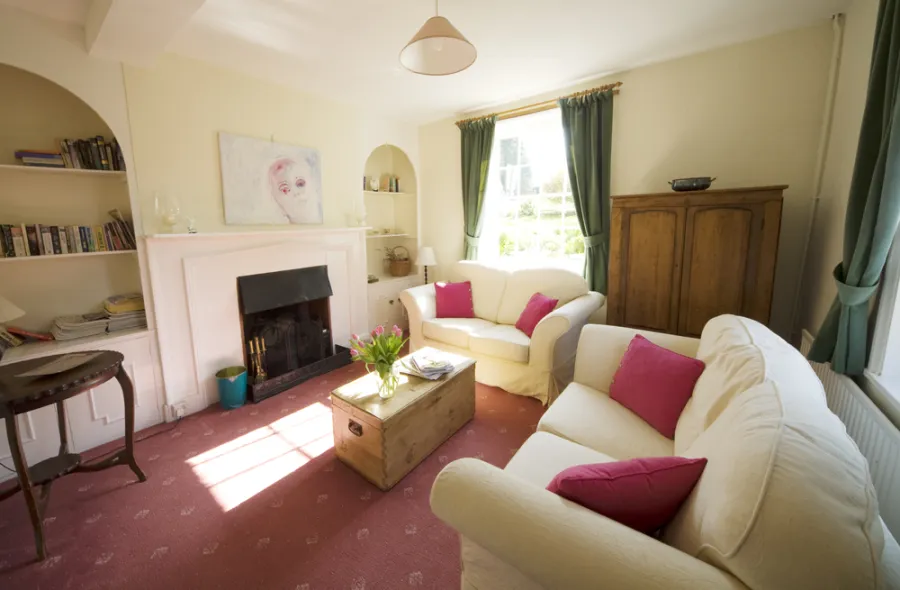 The sitting room, with its open fireplace and view to the garden